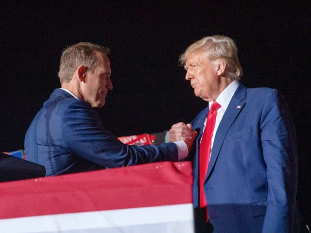 WILMINGTON, NC - SEPTEMBER 23: Representative Ted Budd shakes hands with former President