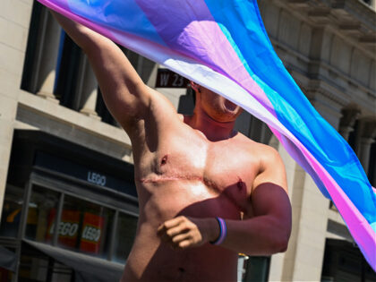 NEW YORK, NEW YORK - JUNE 26: A transgender athlete waves a Trans Pride Flag during the Ne