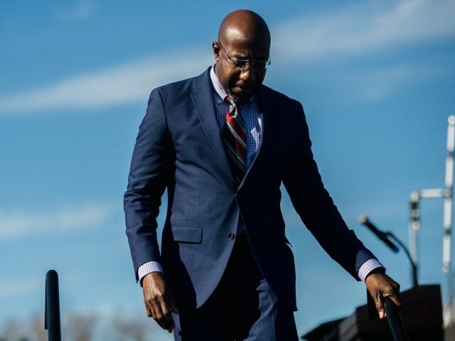 RIVERDALE, GA - JANUARY 04: Senate candidate, the Rev. Raphael Warnock leaves the stage after speaking at a drive-in campaign rally on January 4, 2021 in Riverdale, Georgia. Warnock faces Republican Sen. Kelly Loeffler in tomorrow's run-off election. (Photo by Brandon Bell/Getty Images)
