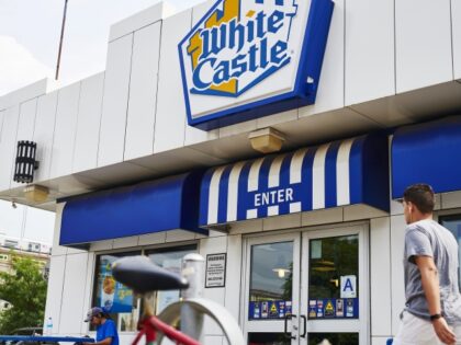 A customer walks towards the entrance of a White Castle restaurant in the Sunnyside neighborhood in the Queens borough of New York, U.S., on Wednesday, July 31, 2019. Imitation meat made by Impossible Foods Inc. has become an unexpected craze, reaching more than 10,000 restaurant menus over the summer, by …