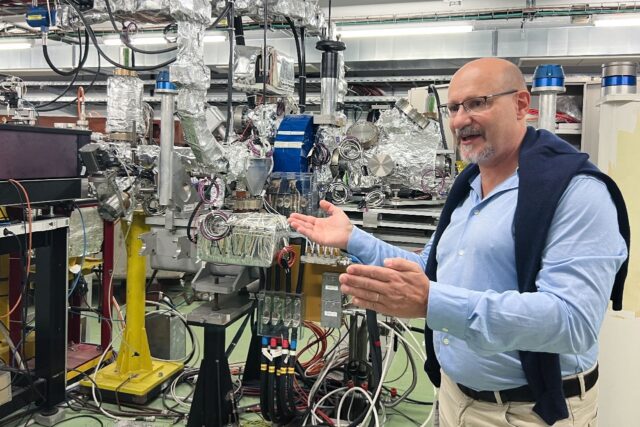 Facility coordinator Roberto Corsini shows off a 40-metre linear particle accelerator at C