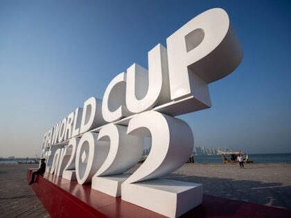 A man poses for photos with a FIFA World Cup sign in Doha on October 25, 2022, ahead of the Qatar 2022 FIFA World Cup football tournament. (Photo by Jewel SAMAD / AFP) (Photo by JEWEL SAMAD/AFP via Getty Images)