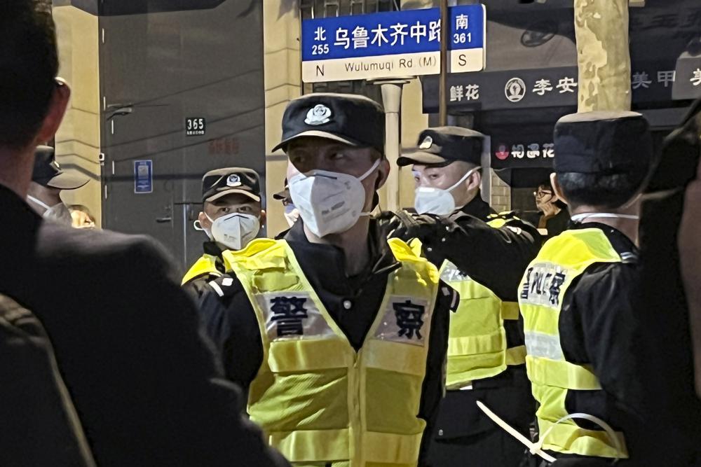 Chinese police officers block off access to a site where protesters had gathered in Shanghai on Sunday, Nov. 27, 2022. Protests against China's strict "zero-COVID" policies resurfaced in Shanghai and Beijing on Sunday afternoon, continuing a round of demonstrations that have spread across the country since a deadly apartment fire in the northwestern city of Urumqi led to questions over such rigid anti-virus measures. (AP Photo)