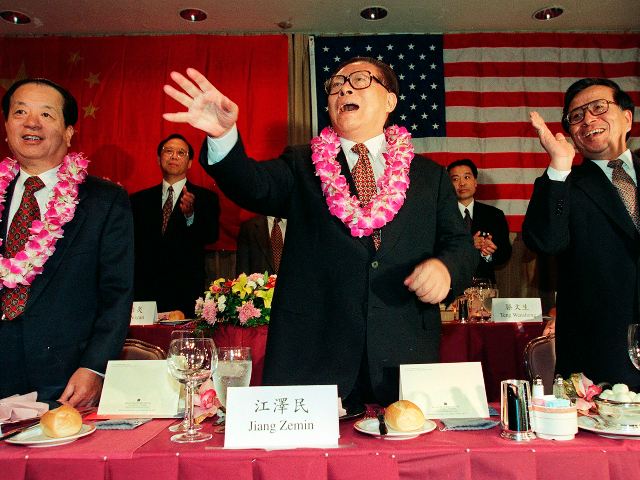 FILE - Chinese then President Jiang Zemin, center, waves as Chinese then Vice President Qian Quichen, left, and Zeng Qinghong, then special assistant to the president, look on at a dinner hosted by the Southern California Chinese American Community in Los Angeles, Nov. 2, 1997. Chinese state TV said Wednesday, Nov. 30, 2022, that Jiang has died at age 96. (Hector Mata/Pool Photo via AP, File)