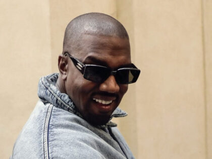 Kanye West attends the Kenzo fall-winter 22/23 men's collection, in Paris, Sunday, Jan. 23, 2022. (AP Photo/Lewis Joly)