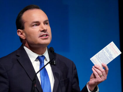FILE - Utah Republican Sen. Mike Lee holds his pocket Constitution of the United States du