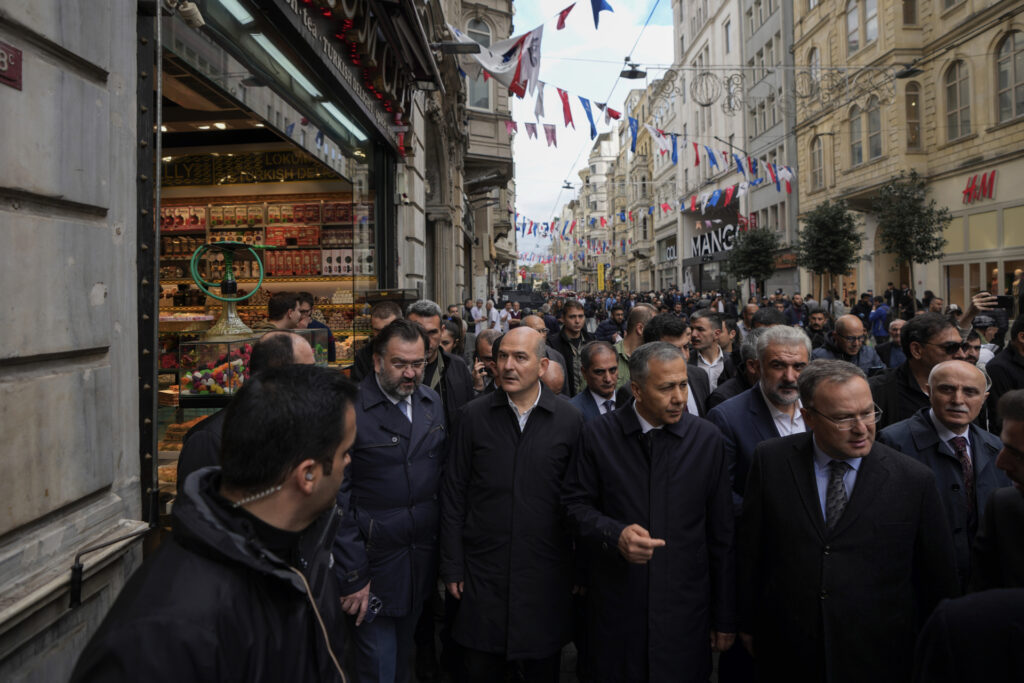 Turkey's Interior Minister Suleyman Soylu, center, visits the scene of Sunday's explosion on Istanbul's popular pedestrian Istiklal Avenue in Istanbul, Monday, Nov. 14, 2022. Turkey's interior minister says police have detained a suspect who is believed to have planted the bomb that exploded on a bustling pedestrian avenue in Istanbul. He said Monday that initial findings indicate that Kurdish militants were responsible for the attack. (AP Photo/Khalil Hamra)