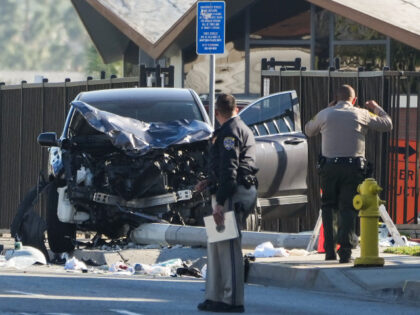 Two investigators stand next to a mangled SUV that struck Los Angeles County sheriff's recruits in Whittier, Calif., Wednesday, Nov. 16, 2022. The vehicle struck several Los Angeles County sheriff's recruits on a training run around dawn Wednesday, some were critically injured, authorities said. (AP Photo/Jae C. Hong)