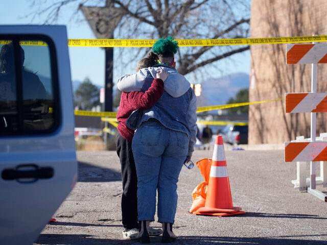 People console each other outside the police tape blocking a drive to Club Q, the site of a weekend mass shooting, Monday, Nov. 21, 2022, in Colorado Springs, Colo. (AP Photo/David Zalubowski)