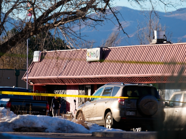 An FBI agent walks outside of Club Q, the site of a weekend mass shooting, Monday, Nov. 21, 2022, in Colorado Springs, Colo. (AP Photo/Jack Dempsey)