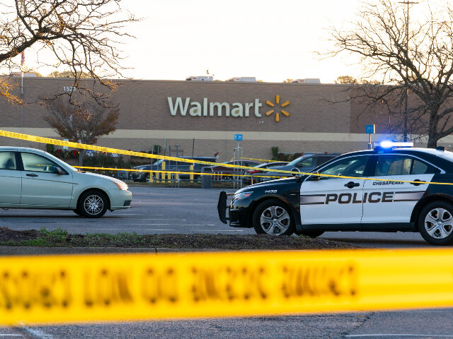 Law enforcement work the scene of a mass shooting at a Walmart, Wednesday, Nov. 23, 2022, in Chesapeake, Va. The store was busy just before the shooting Tuesday night with people stocking up ahead of the Thanksgiving holiday. (AP Photo/Alex Brandon)