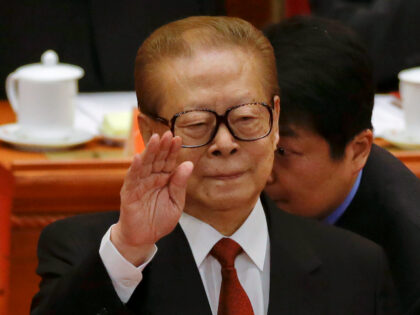 FILE - Former Chinese President Jiang Zemin gestures during the opening session of the 18t