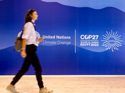 HARM EL SHEIJK, SOUTH SINAI, EGYPT - 2022/11/05: Participant walks in front of the UN COP27 logo as she arrives at the COP27 UN Climate Change Conference held by UNFCCC in Sharm El-Sheikh International Convention Center. COP27, running from November 6 to November 18 in Sharm El Sheikh focuses on …