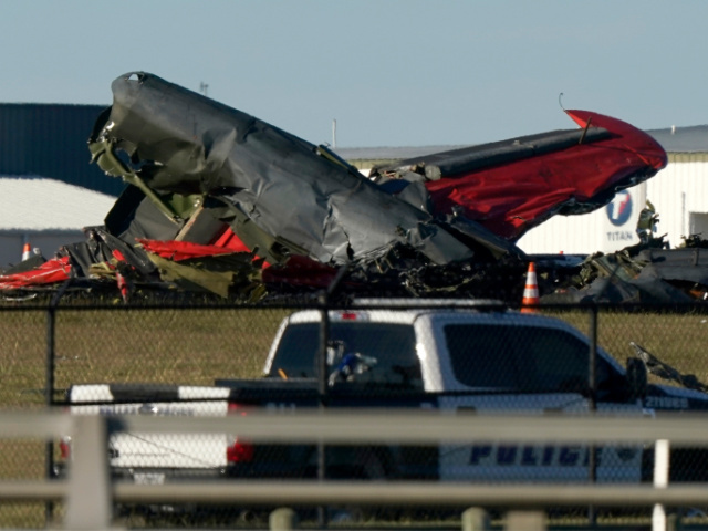 Debris from two planes that crashed during an airshow at Dallas Executive Airport lie on t
