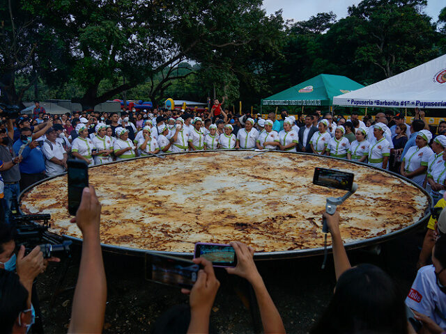 LA PAZ, EL SALVADOR - NOVEMBER 13: Salvadoran cooks poses for a photo with the most gigantic pupusa in the world, during the 18th Festival of the Pupusa in the municipality of Olocuilta in La Paz, El Salvador, on November 13, 2022. Since 2005, the "National Pupusa Day" is celebrated …