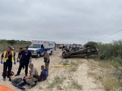 Texas DPS troopers and EMS workers render aid to 12 illegal aliens who were ejected from a pickup truck in a rollover crash near La Joya, Texas. (Texas Department of Public Safety)
