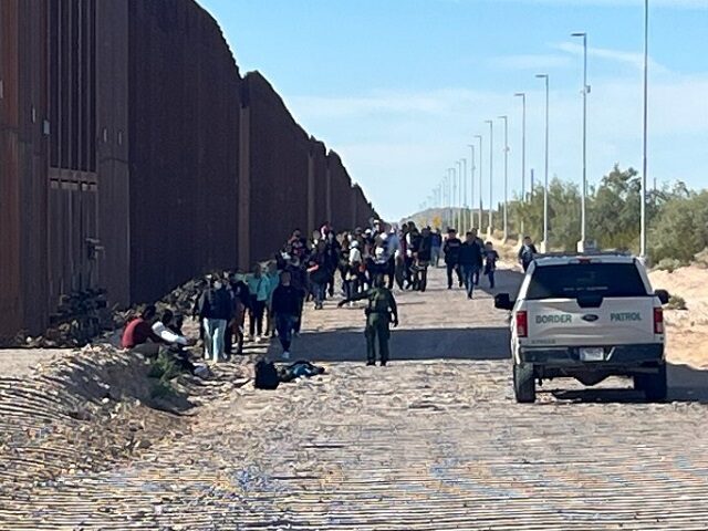 Ajo Station Border Patrol agents apprehend a group of 56 migrants near the border wall wes