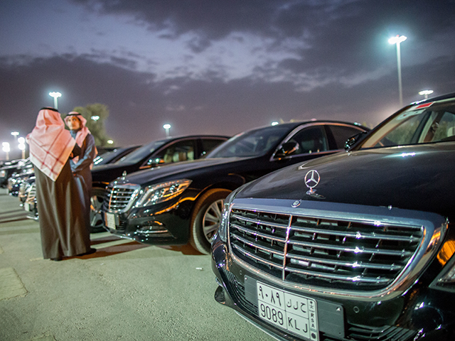 People stand in front of their Mercedes cars at the Al-Jenadriyah festival in Riad, Saudi