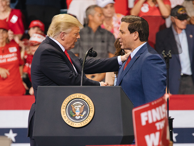 U.S. President Donald Trump, left, shakes hands with Representative Ron DeSantis, Republican candidate for governor of Florida, during a campaign rally in Estero, Florida, U.S., on Wednesday, Oct. 31, 2018. Trump doubled down on his vow to deny U.S. citizenship to children born of unauthorized immigrants as he kicked off …