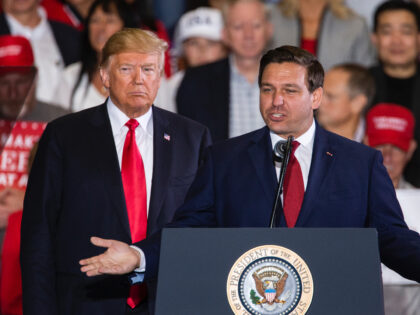 PENSACOLA, FL - NOVEMBER 03: Florida Republican gubernatorial candidate Ron DeSantis speaks with U.S. President Donald Trump at a campaign rally at the Pensacola International Airport on November 3, 2018 in Pensacola, Florida. President Trump is campaigning in support of Republican candidates in the upcoming midterm elections. (Photo by Mark …