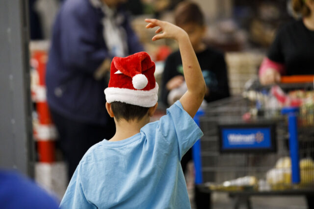 A child wears a Santa Claus hat at a Walmart Inc. store in Burbank, California, U.S., on Monday, Nov. 19, 2018. To get the jump on Black Friday selling, retailers are launching Black Friday-like promotions in the weeks prior to the event since competition and price transparency are forcing retailers …