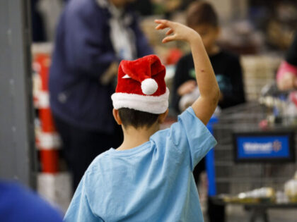 A child wears a Santa Claus hat at a Walmart Inc. store in Burbank, California, U.S., on M