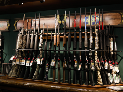 Rifles for sale sit on display at the firearms department inside a Bass Pro Outdoor World