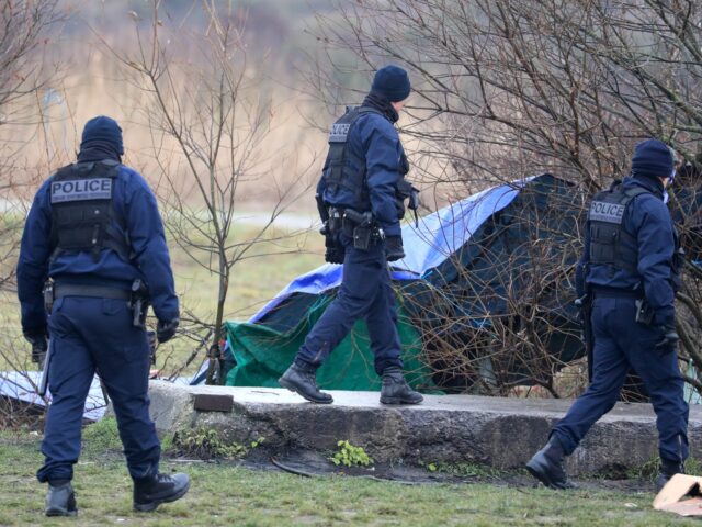 French police officers arrive to break up a migrant camp in Calais, France, following the
