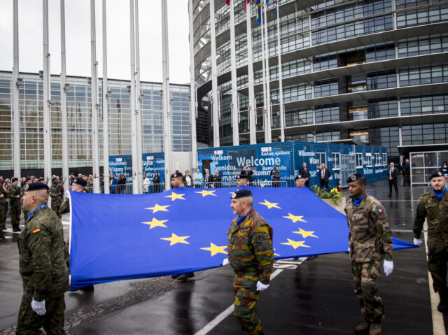 Soldiers of a Eurocorps detachment raise the European Union flag during the open day at th