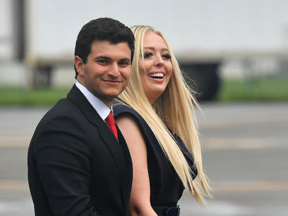 Michael Boulos and Tiffany Trump wait for the arrival of US President Donald Trump and Fir