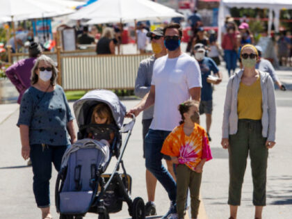 VENTURA, CA - AUGUST 01: Pedestrians on Main Street where masks are required in public in the city of Ventura, which has opened up with restrictions on traffic and other activities on Saturday, Aug. 1, 2020 in Ventura, CA. (Brian van der Brug / Los Angeles Times via Getty Images)