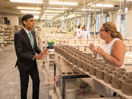 STOKE-ON-TRENT, ENGLAND - SEPTEMBER 14: Chancellor Rishi Sunak chats to Michelle Oakes during a visit to the Emma Bridgewater pottery after employees returned back to work after being furloughed on September 14, 2020 in Stoke-on-Trent, England. (Photo by Andrew Fox - WPA Pool / Getty Images)