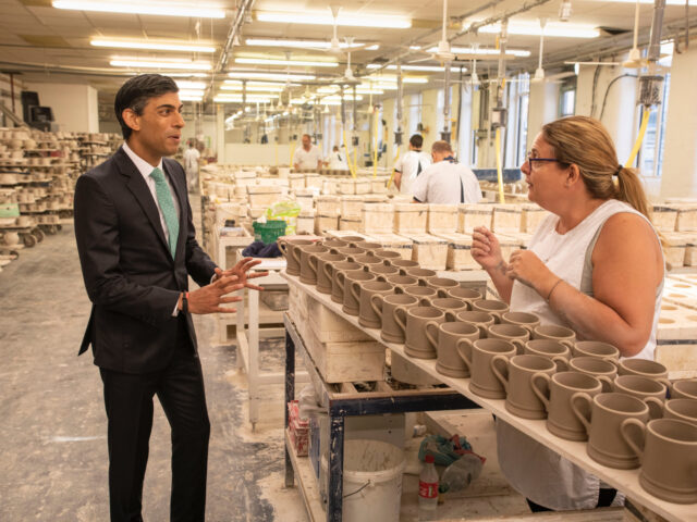 STOKE-ON-TRENT, ENGLAND - SEPTEMBER 14: Chancellor Rishi Sunak chats to Michelle Oakes dur