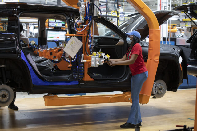 DETROIT, MI - JUNE 10: A Steelantis worker installs a door on a 2021 Jeep Grand Cherokee L