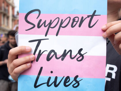 LONDON, UNITED KINGDOM - 2021/06/26: A placard that says 'support trans lives' printed against the transgender pride flag during the march. The Transgender Pride rally were coordinated by Socialist Workers, calling for protection of the rights of transgender people in the UK. The march took place in Leicester Square. (Photo …