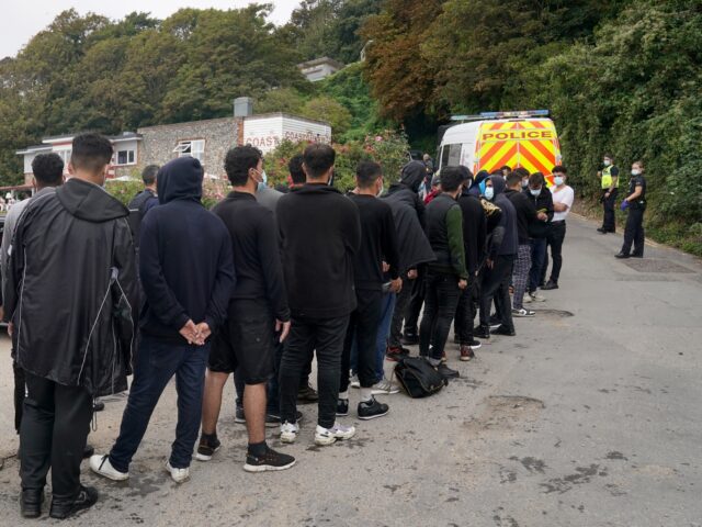 A group of people thought to be migrants are escorted by Police and Border Force officers