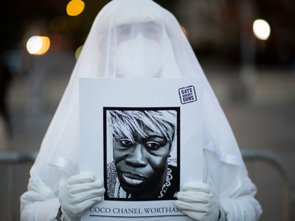 A person holds a photo of a transgender victim during the Transgender Day of Remembrance in Washington square park in New York on November 20, 2021. (Photo by KENA BETANCUR / AFP) (Photo by KENA BETANCUR/AFP via Getty Images)