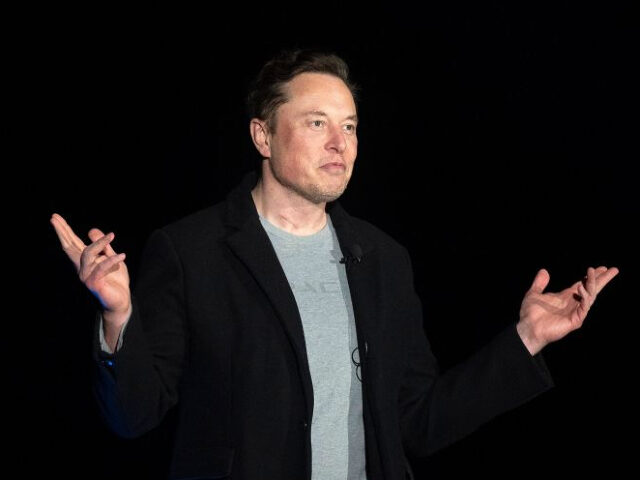 Elon Musk gestures as he speaks during a press conference at SpaceX's Starbase facility ne
