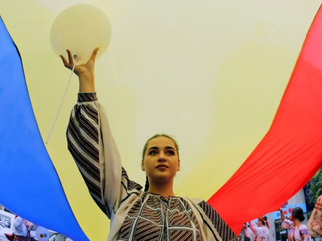A woman wearing traditional clothes attends a ceremony celebrating Romania's National