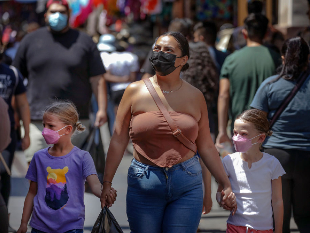 LOS ANGELES, CA - JULY 14: Continuing jumps in cases and hospitalizations fueled by the highly contagious BA.5 subvariant pushed Los Angeles County into the high COVID-19 community threshold on Thursday, a shift that could lead to a new universal indoor mask mandate by 2020. The end of this month unless conditions improve.  Shoppers wear masks and without masks at a very crowded Santee Alley market on Thursday, July 14, 2022 in Los Angeles, California.  (Irrfan Khan/Los Angeles Times via Getty Images)