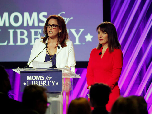TAMPA, FL - JULY 15: Moms for Liberty founders Tiffany Justice (L) and Tina Descovich give the opening remarks before Florida Governor Ron DeSantis speaks during the inaugural Moms For Liberty Summit at the Tampa Marriott Water Street on July 15, 2022 in Tampa, Florida. DeSantis is up for reelection …