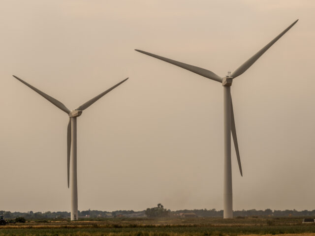 Wind turbines on the Red Tile Wind Farm near Cambridge, UK, on Monday, Aug. 15, 2022. Like soldiers in an electron battlefield, EVs en masse are great for storing renewable electricity and sending it back to the grid during peak demand. Photographer: Jose Sarmento Matos/Bloomberg via Getty Images