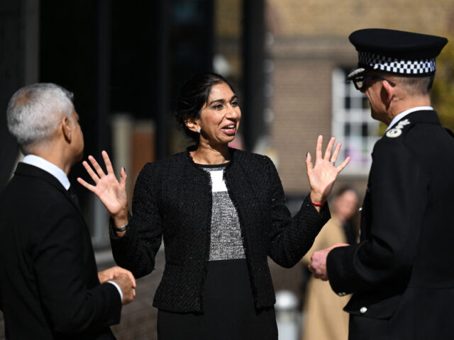 Britain's Home Secretary Suella Braverman (C) speaks with Metropolitan Police Commissioner