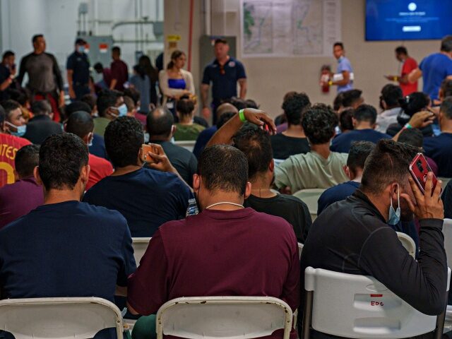 Migrants wait after being released from immigration detention at a Welcome Center in El Paso, Texas, US, on Thursday, Sept. 22, 2022. Less than two weeks before the end of the federal fiscal year, encounters between migrants and Border Patrol agents on the U.S.-Mexico border have already surpassed 2 million …
