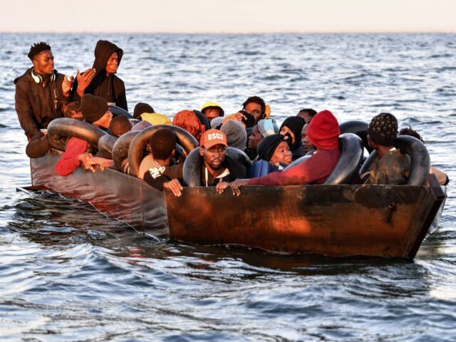 Migrants from sub-Saharan Africa sit in a makeshift boat that was being used to clandestin