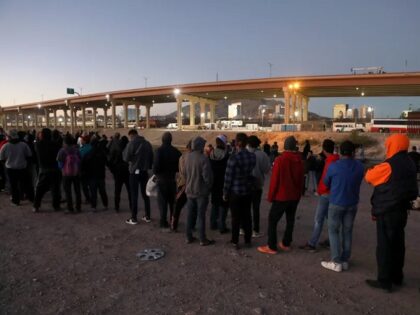 Venezuelan migrants line up to cross the border from Mexico into El Paso, Texas, in October 2022. (Herika Martinez/AFP Via Getty)