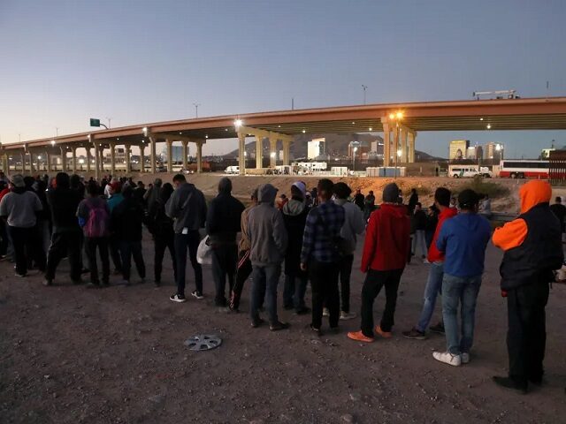 Venezuelan migrants line up to cross the border from Mexico into El Paso, Texas, in October 2022. (Herika Martinez/AFP Via Getty)