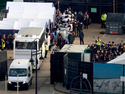 People thought to be migrants wait to be processed at the Border Force compound in Dover, Kent, after being brought from Border Force vessels following a number of small boat incidents in the Channel. Picture date: Saturday October 29, 2022. (Photo by Gareth Fuller/PA Images via Getty Images)