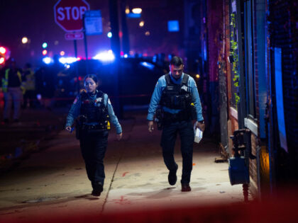 Chicago police walk near the corner of Polk Street and California Avenue after a mass shooting occurred on Halloween night on the city&apos;s West Side. (E. Jason Wambsgans/Chicago Tribune/Tribune News Service via Getty Images)