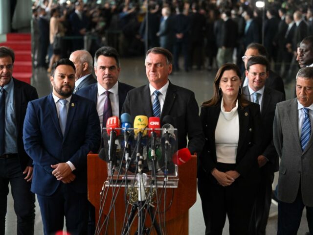 Brazilian President Jair Bolsonaro (C) makes a statement for the first time since Sunday's